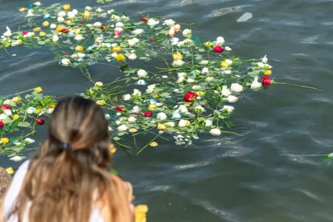 Roses floating on calm water during an ashes at sea memorial in St. Augustine, FL