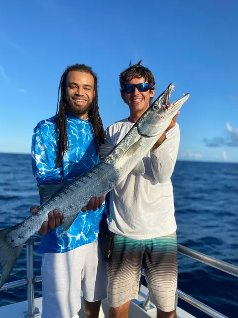 Two anglers holding a big barracuda on a charter trip out of St. Augustine, FL