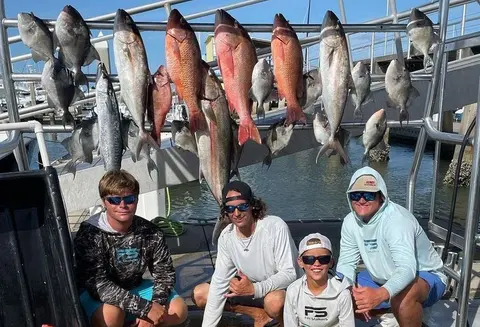 Group of anglers under a full catch board after a charter trip from Atlantic Beach, FL