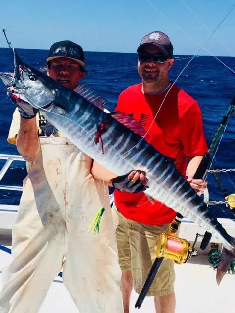 Anglers holding up a wahoo caught offshore from Orange Park, FL
