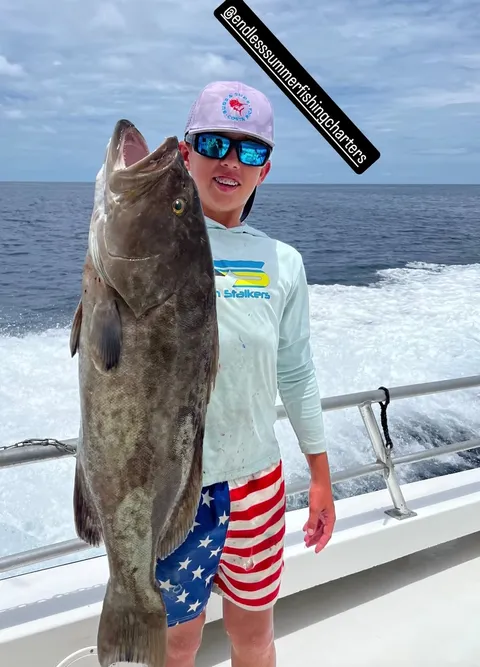 Young angler holding a gag grouper, from an Endless Summer Charters social post